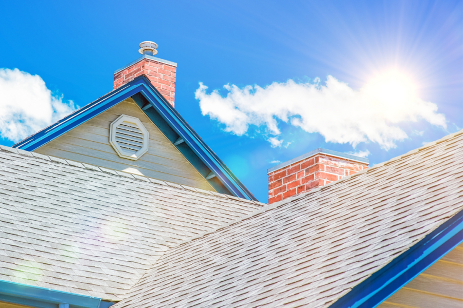 sun shining above shingle roof